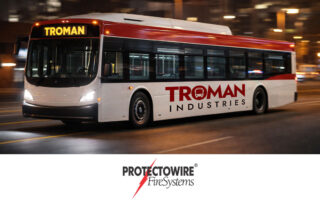 Transit fire detection system partnership between Troman Industries and Protectowire FireSystems with transit bus image